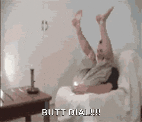 a man is laying on a couch with his legs in the air and says `` butt dial '' .