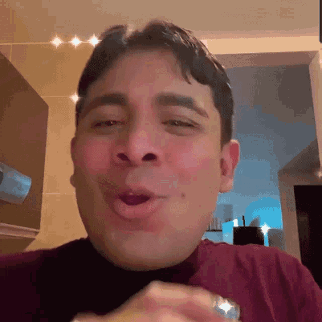 a man with a ring on his finger is making a face