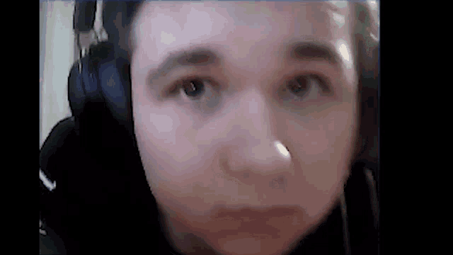 a close up of a young man wearing headphones .