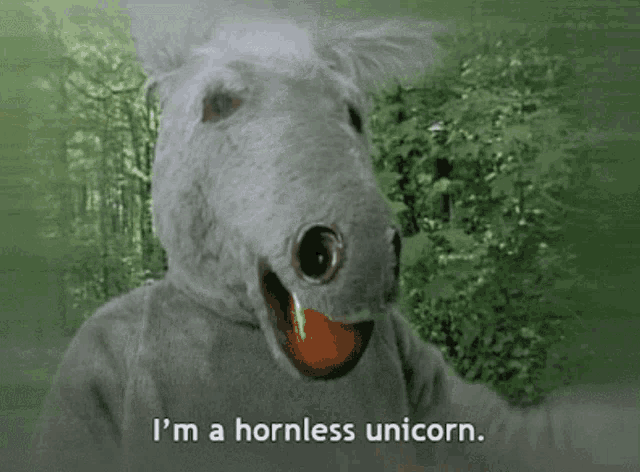 a person dressed as a hornless unicorn with a ball in its mouth