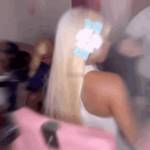 a woman with blonde hair and a blue flower in her hair