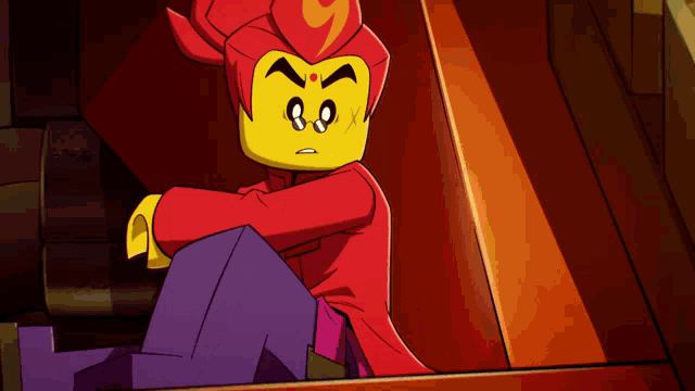 a cartoon character with a red head and purple pants is sitting down