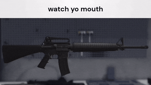 a picture of an assault rifle with the words watch yo mouth below it