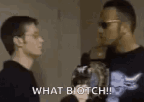 two men are standing next to each other and one of them is talking to the other .