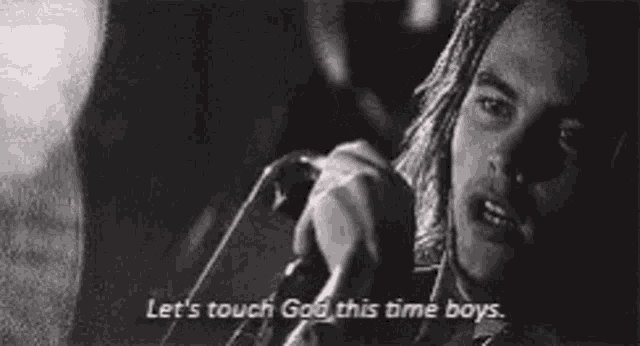 a man talking on a phone with the words let 's touch god this time boys below him