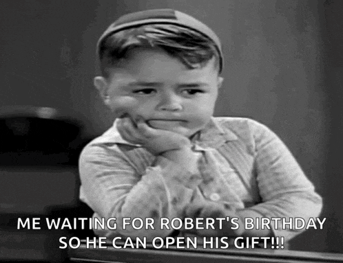 a little boy is waiting for robert 's birthday so he can open his gift !!