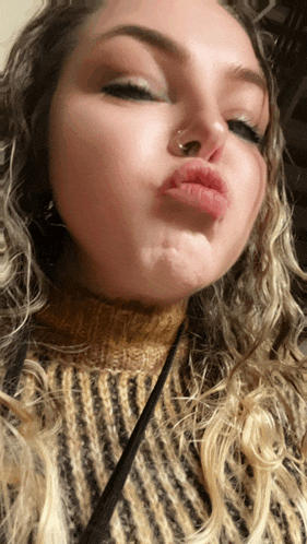 a woman with a nose ring is making a face