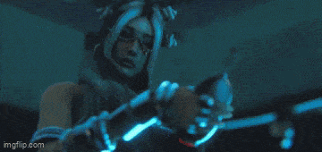 a robotic arm is holding a blue object in the air .
