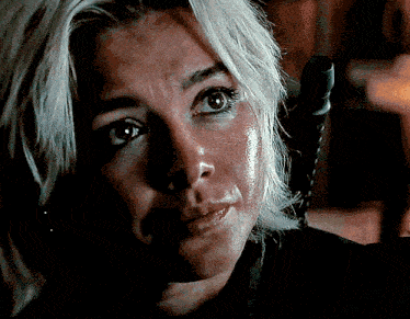 a close up of a woman 's face with a black shirt on