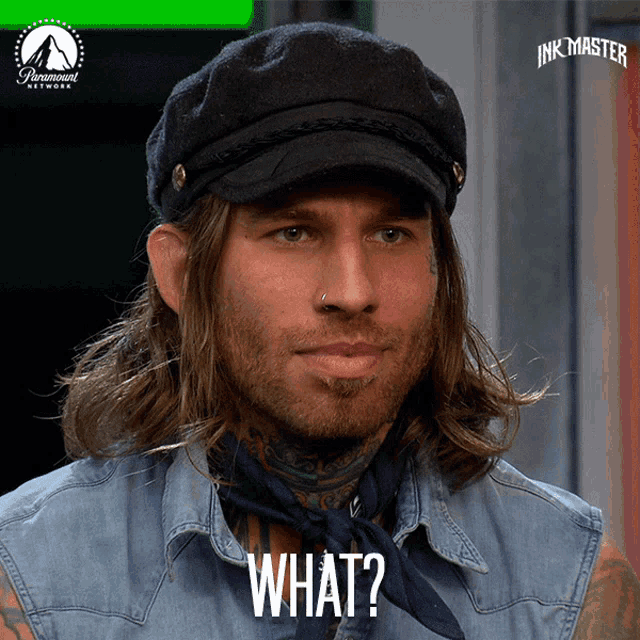 a man with long hair wearing a hat and a bandana says " what "