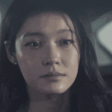a woman with a tear running down her cheek