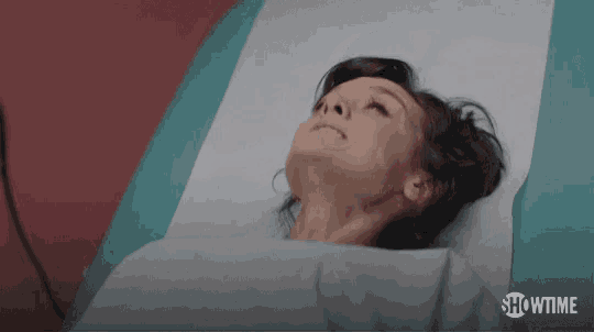 a woman is laying in a hospital bed with showtime written on the bottom of the screen