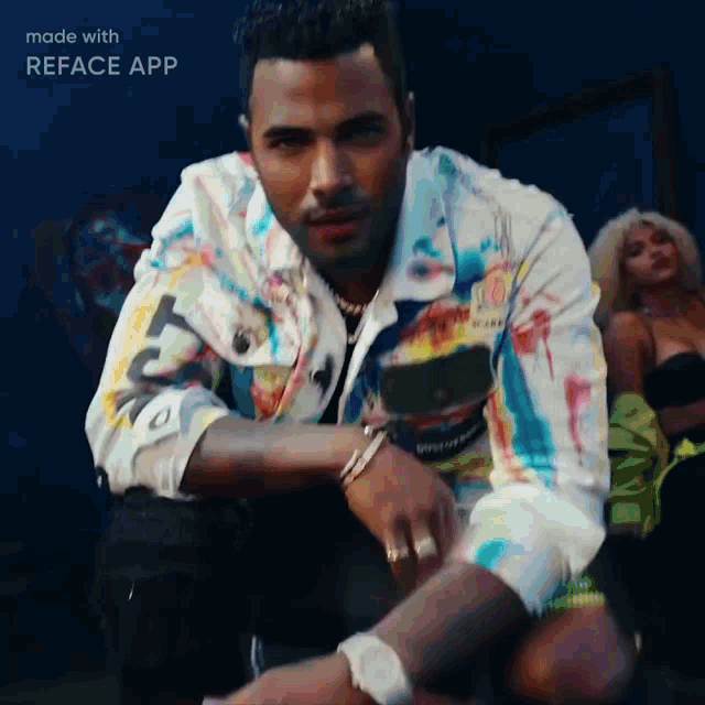 a man in a colorful jacket is sitting in front of a woman in a black top
