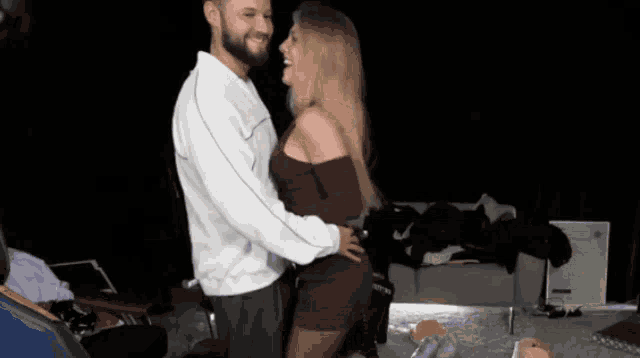 a man and a woman are hugging and laughing