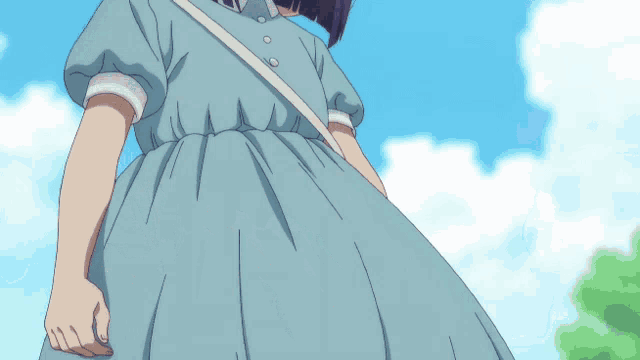 a girl in a blue dress and straw hat looks up at the sky