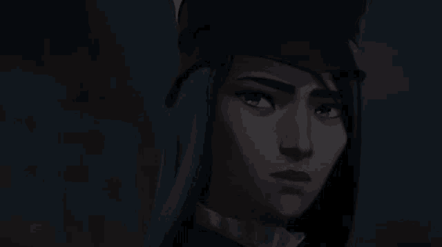 a close up of a woman 's face wearing a hat in a dark room .