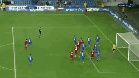 a soccer game is being played on a field that has a banner that says extreme
