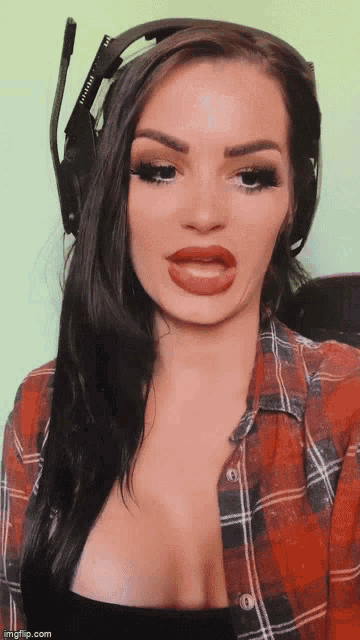 a woman wearing a plaid shirt and headphones with the word infinity on the headband