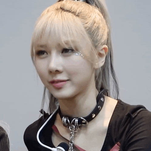 a woman with blonde hair wearing a black choker