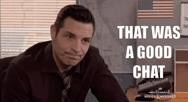a man sitting at a desk with the words that was a good chat on the bottom