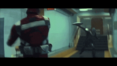 a man in a red and white uniform is running down a hallway .