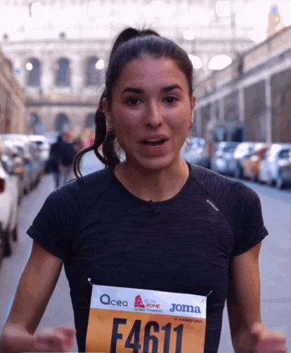 a woman wearing a bib that says f4611 is running