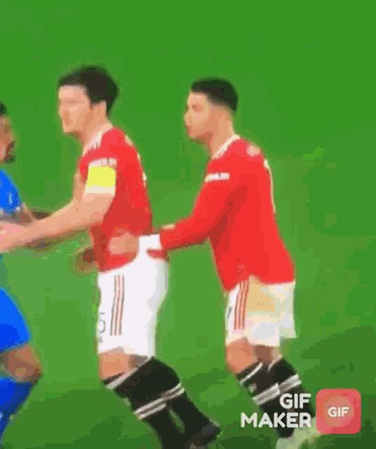 a soccer game is being played on a field with a playstation advertisement in the background