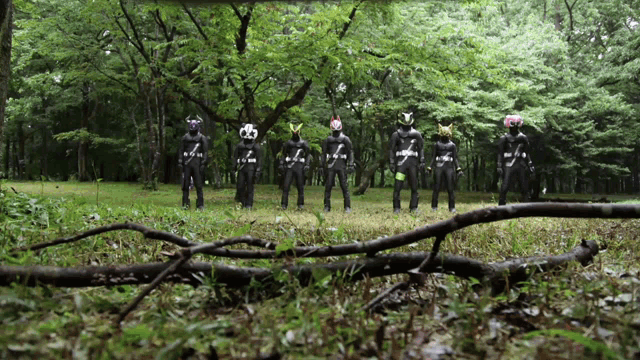a group of people standing in a field with one wearing a mask that has the number 7 on it