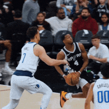 a basketball player with the number 4 on his jersey tries to block another player