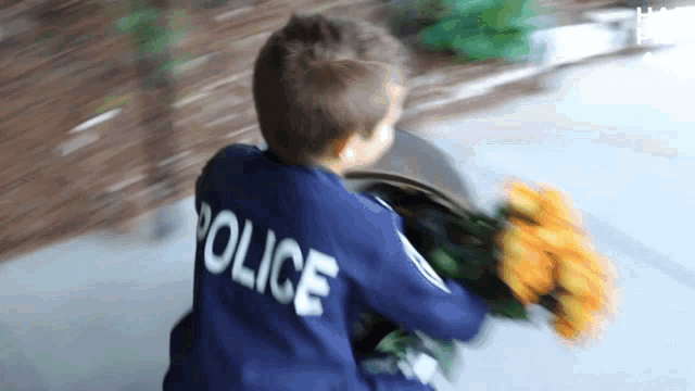 a young boy wearing a blue police uniform