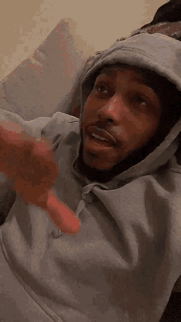a man wearing a grey hoodie with the word nike on it