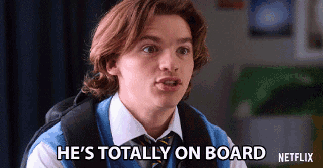 a young man in a blue vest and tie says he 's totally on board