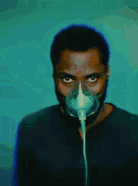 a man with a beard wearing an oxygen mask on his face .