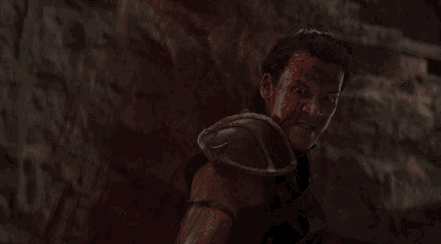 a man with blood coming out of his mouth and shoulder