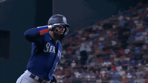 two baseball players are talking to each other in a stadium .