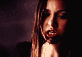a close up of a woman with blood on her face