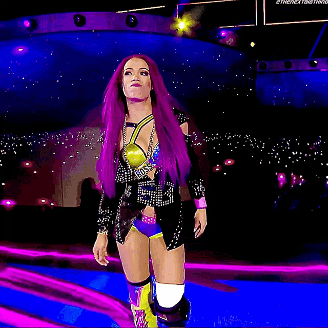 a woman with purple hair is walking on a stage with the hashtag #thenextthing