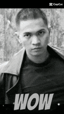 a black and white photo of a man with the word wow on the bottom right