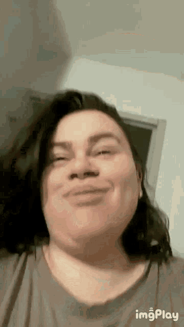 a woman with long hair is smiling for the camera .