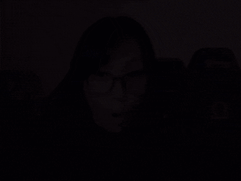 a woman wearing glasses and a black shirt that says amd