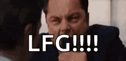 a man in a suit is pointing at another man with the words `` lfg !!! '' written on the screen .