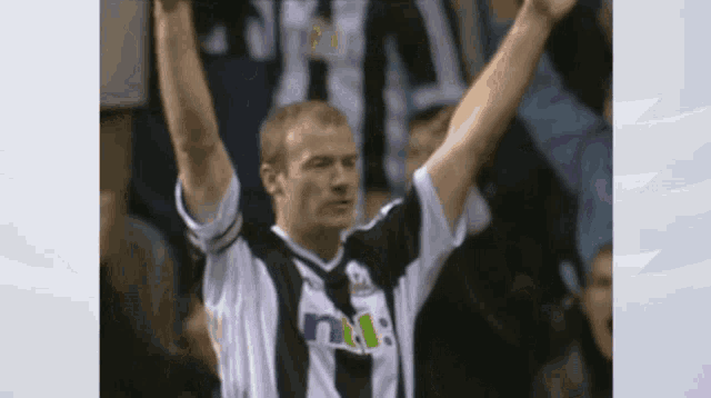 a man in a black and white shirt with the letter n on the front