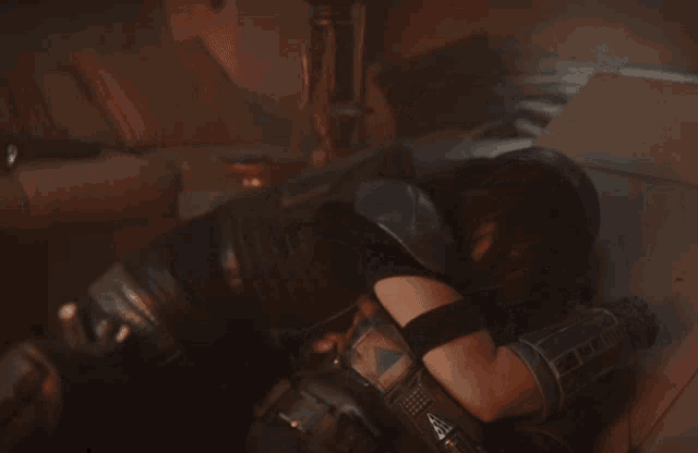 a woman in a black leather outfit is hugging a man in a helmet