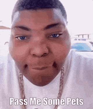 a man wearing a white shirt and a gold chain is making a funny face .