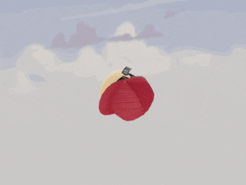 a red ball of yarn is flying through the air