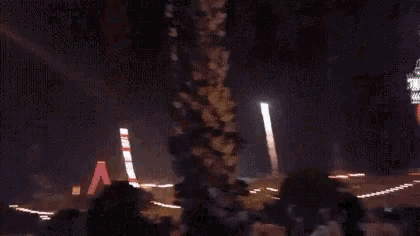 a fireworks display is taking place in the night sky .