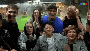 a group of people are posing for a picture together and smiling