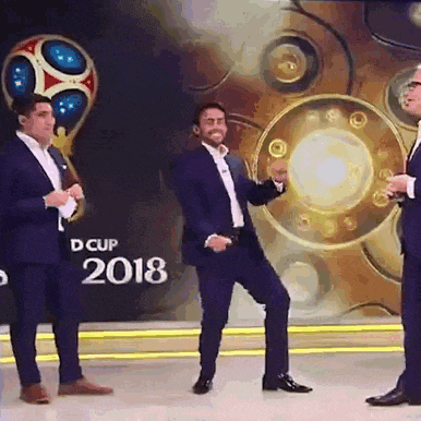 a man in a suit is dancing in front of a sign that says d cup 2018