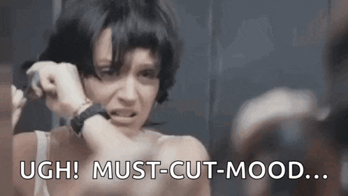 a woman is looking at herself in a mirror and saying `` ugh ! must-cut-mood ... '' .