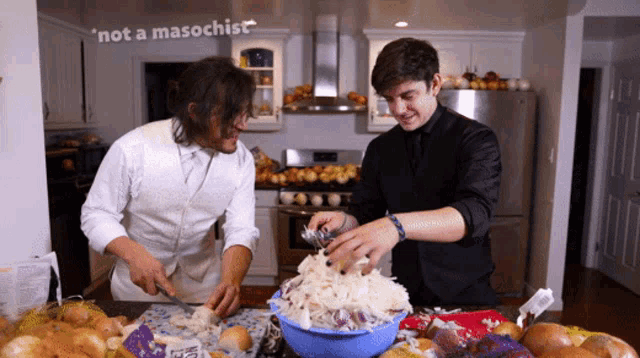 two men cooking in a kitchen with a sign that says " not a masochist " above them